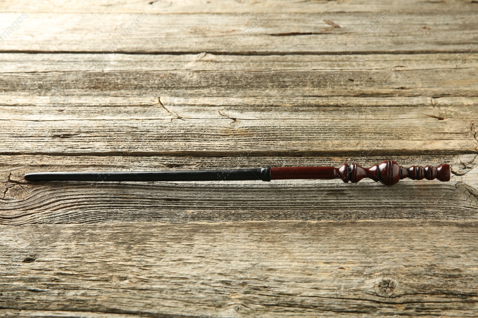 Photo of One old magic wand on wooden table