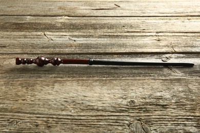 One old magic wand on wooden table