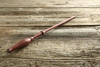 Photo of One magic wand on wooden table, closeup