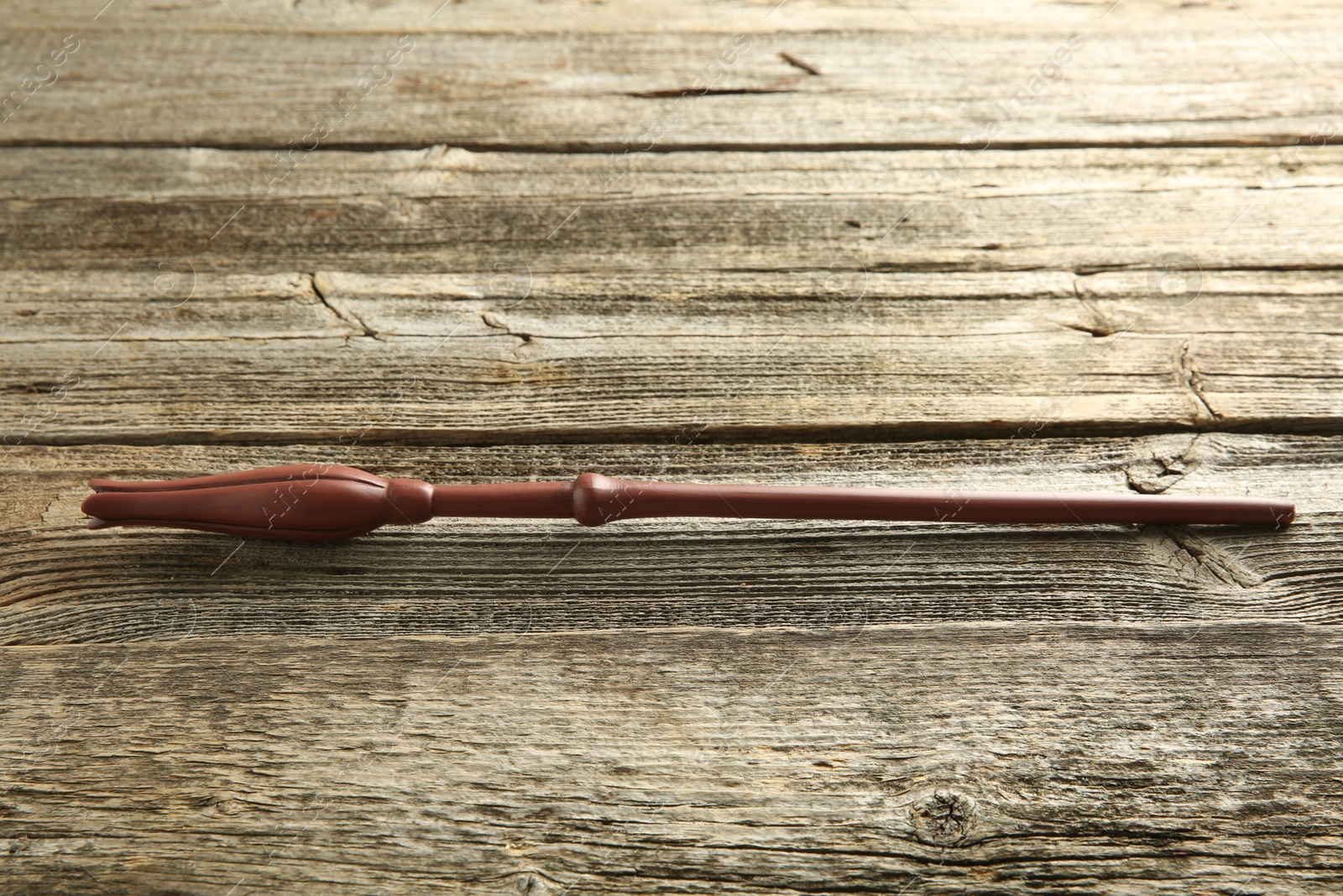 Photo of One old magic wand on wooden table