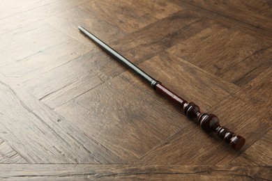 One magic wand on wooden table, closeup