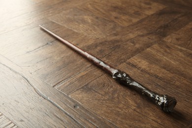 Photo of One magic wand on wooden table, closeup