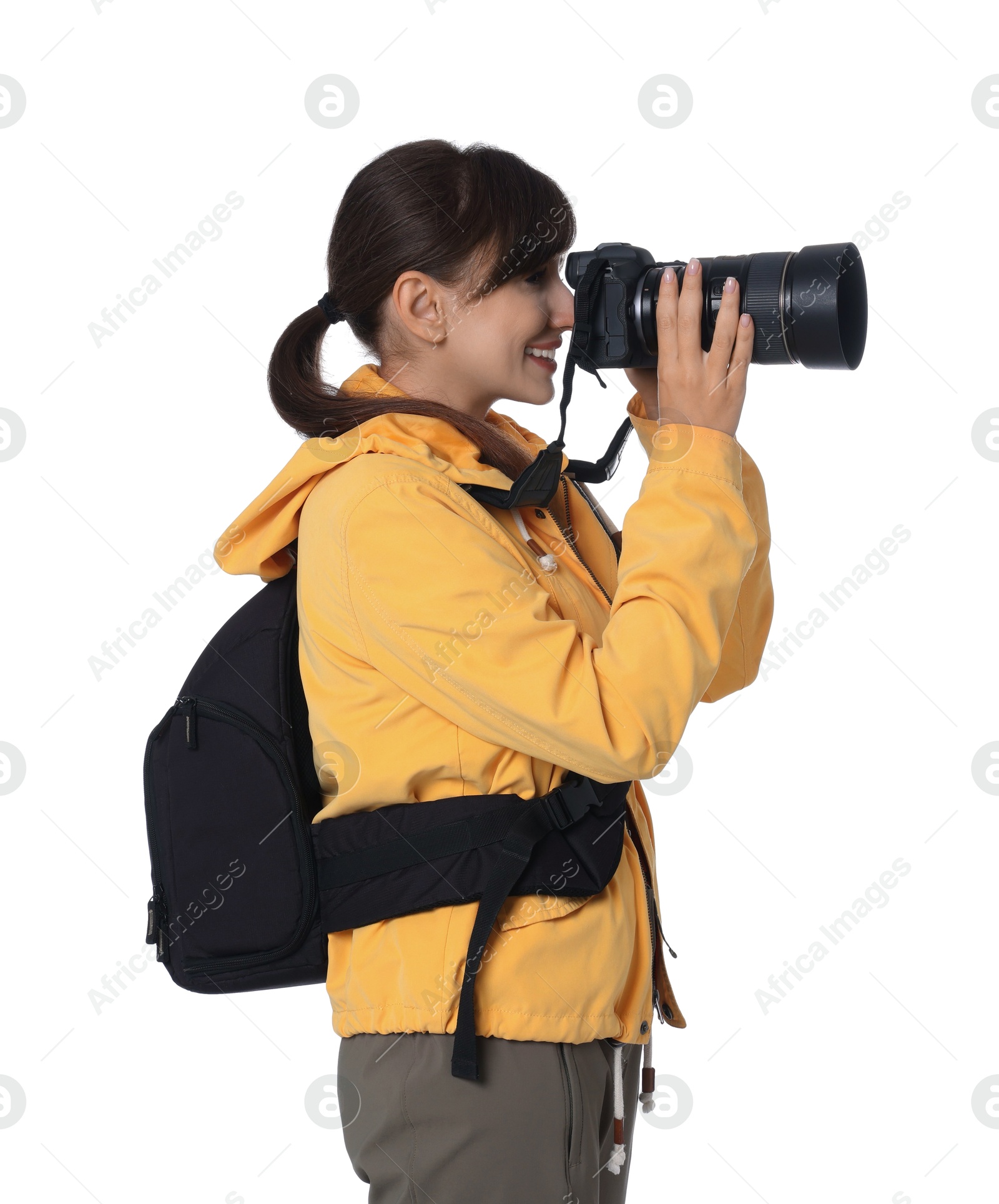 Photo of Photographer with backpack and camera taking picture on white background