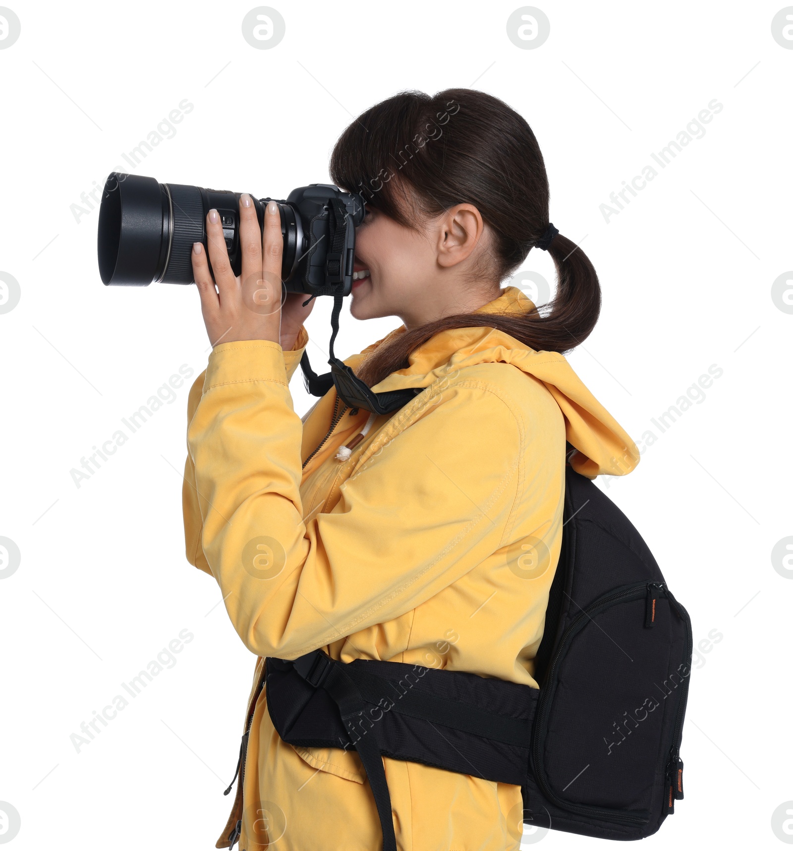 Photo of Photographer with backpack and camera taking picture on white background