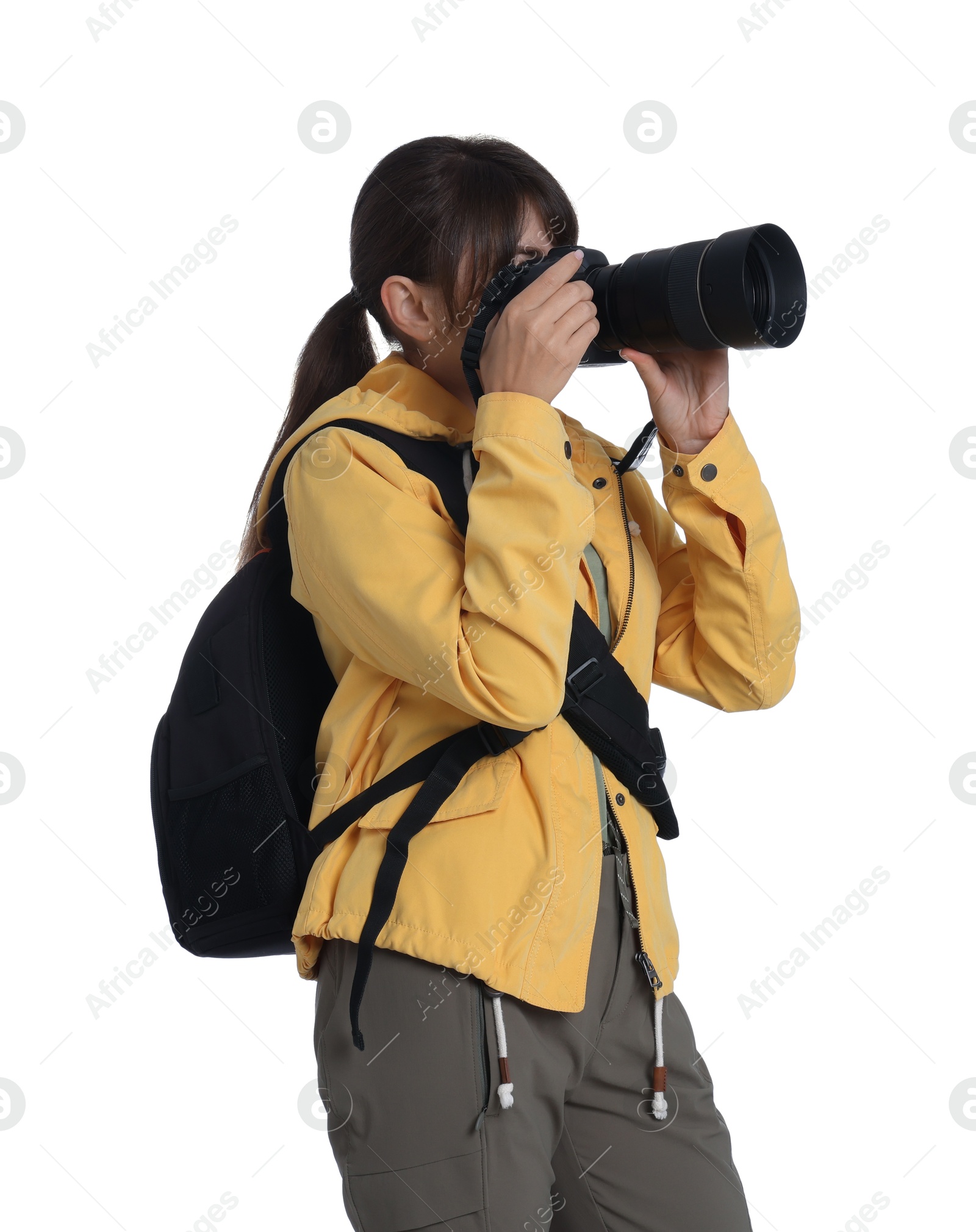 Photo of Photographer with backpack and camera taking picture on white background