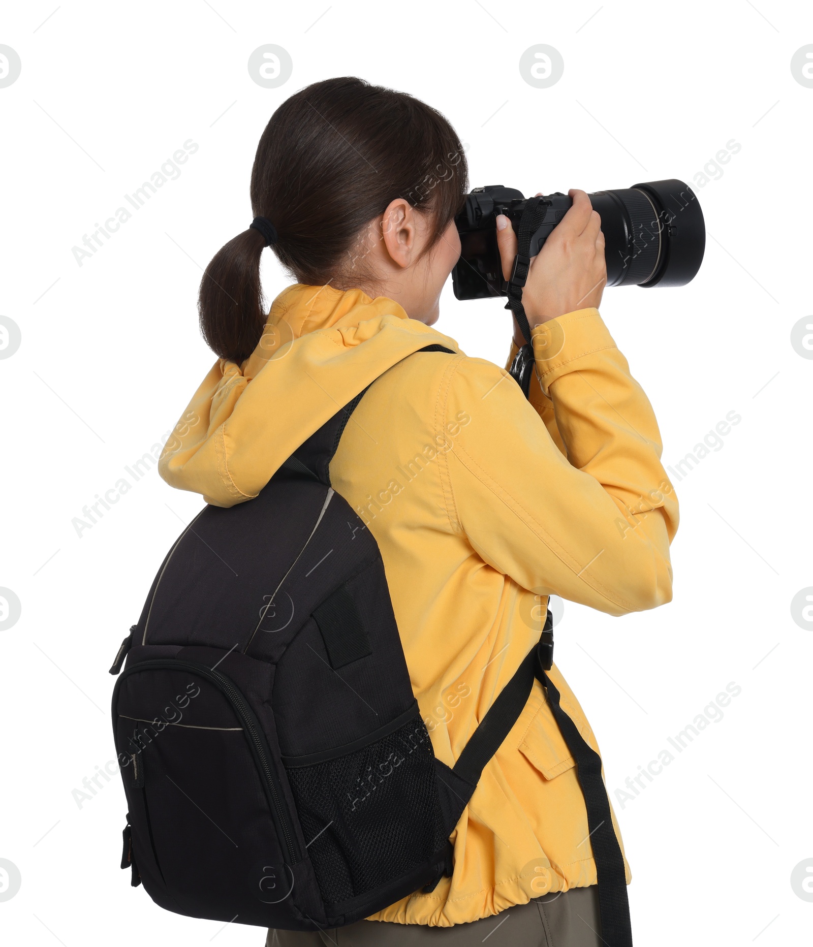 Photo of Photographer with backpack and camera taking picture on white background