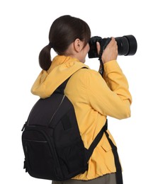 Photographer with backpack and camera taking picture on white background