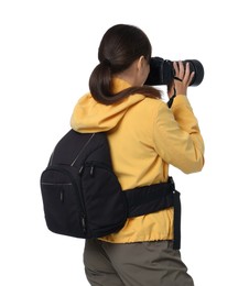 Photo of Photographer with backpack and camera taking picture on white background