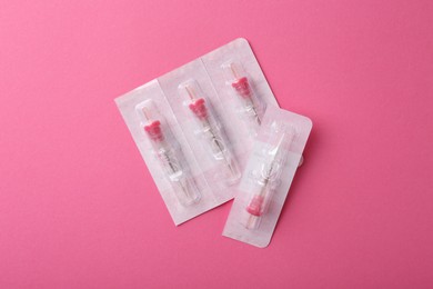 Photo of Disposable cartridge systems for permanent makeup on pink background, top view