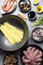 Photo of Ingredients for wok on grey table, flat lay