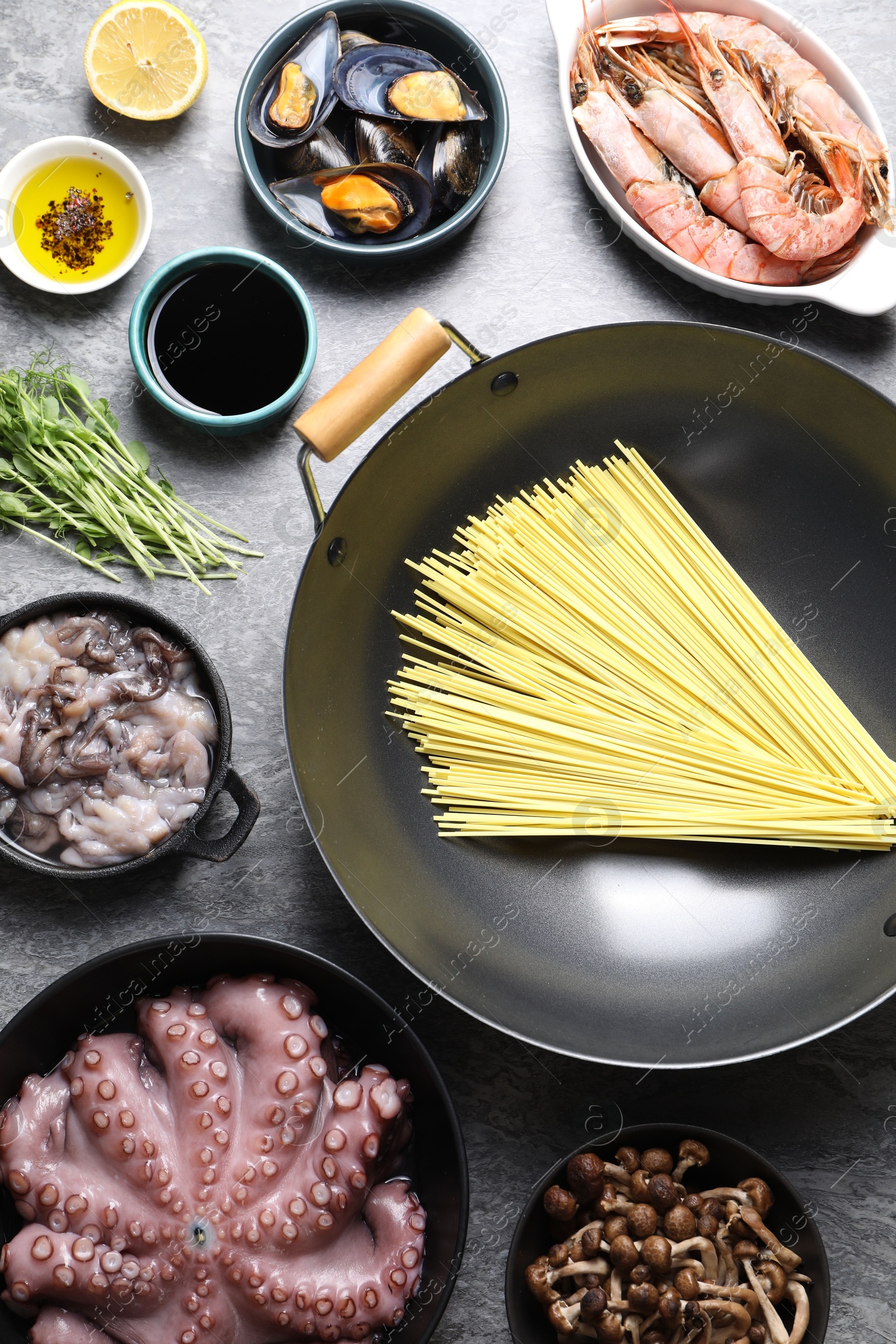 Photo of Ingredients for wok on grey table, flat lay