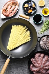 Photo of Ingredients for wok on grey table, flat lay