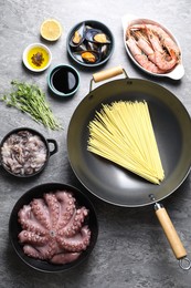 Photo of Ingredients for wok on grey table, flat lay