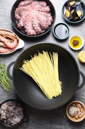 Photo of Ingredients for wok on grey table, flat lay