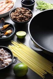 Photo of Ingredients for wok on grey table, closeup