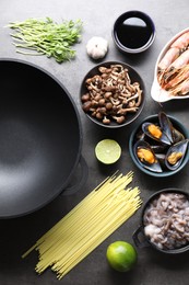 Photo of Ingredients for wok on grey table, flat lay