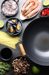 Photo of Ingredients for wok on grey table, flat lay