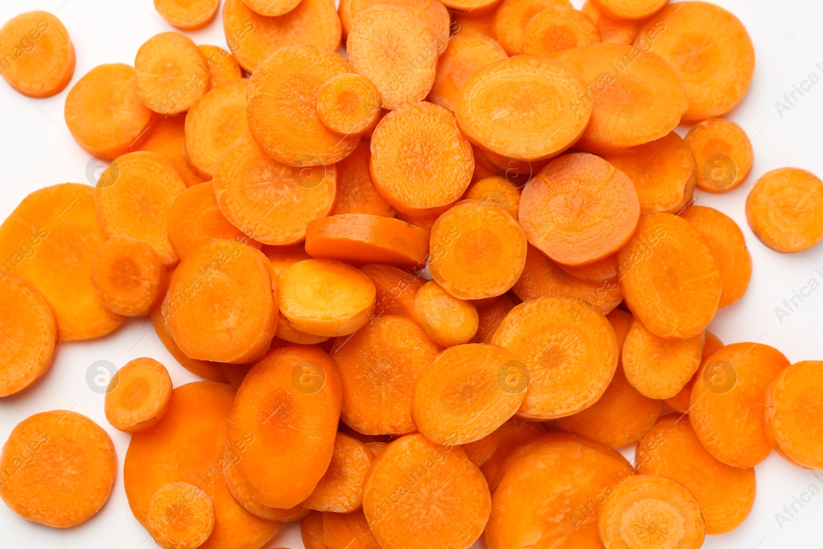 Photo of Slices of fresh ripe carrot on white background, top view