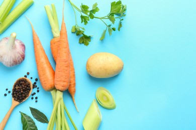 Photo of Fresh ripe carrots, vegetables, spices and spoon on light blue background, flat lay. Space for text