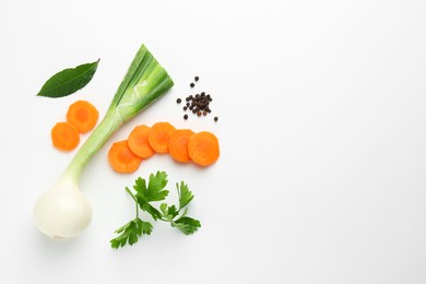 Photo of Pieces of fresh ripe carrot, onion and spices on white background, flat lay. Space for text