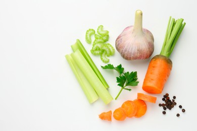 Photo of Fresh ripe carrot, vegetables and spices on white background, flat lay. Space for text