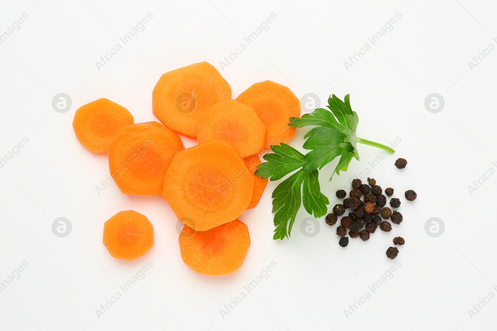 Photo of Pieces of fresh ripe carrot and spices on white background, flat lay