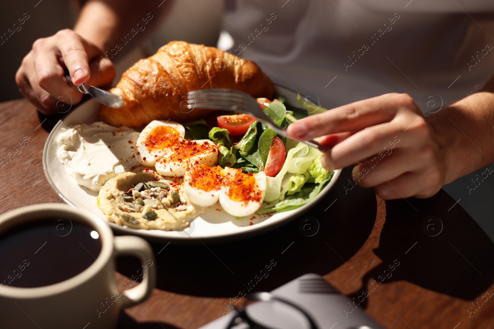 Photo of Man having tasty breakfast in cafe, closeup