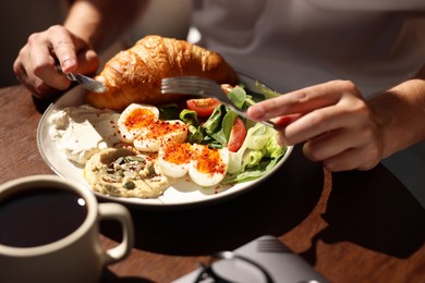 Photo of Man having tasty breakfast in cafe, closeup