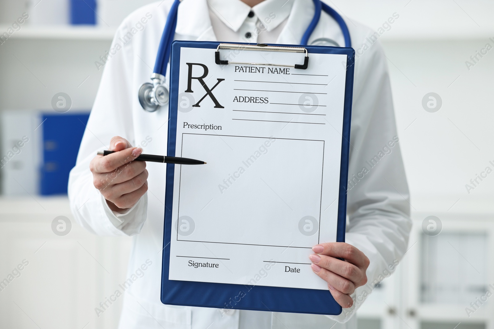 Photo of Doctor with blank prescription form in clinic, closeup