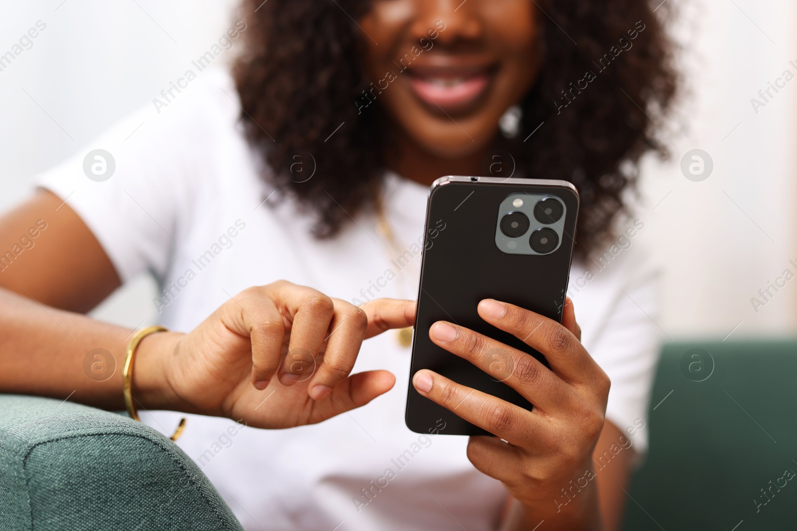 Photo of Woman using mobile phone at home, closeup