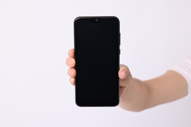 Photo of Woman holding smartphone with blank screen on white background, closeup