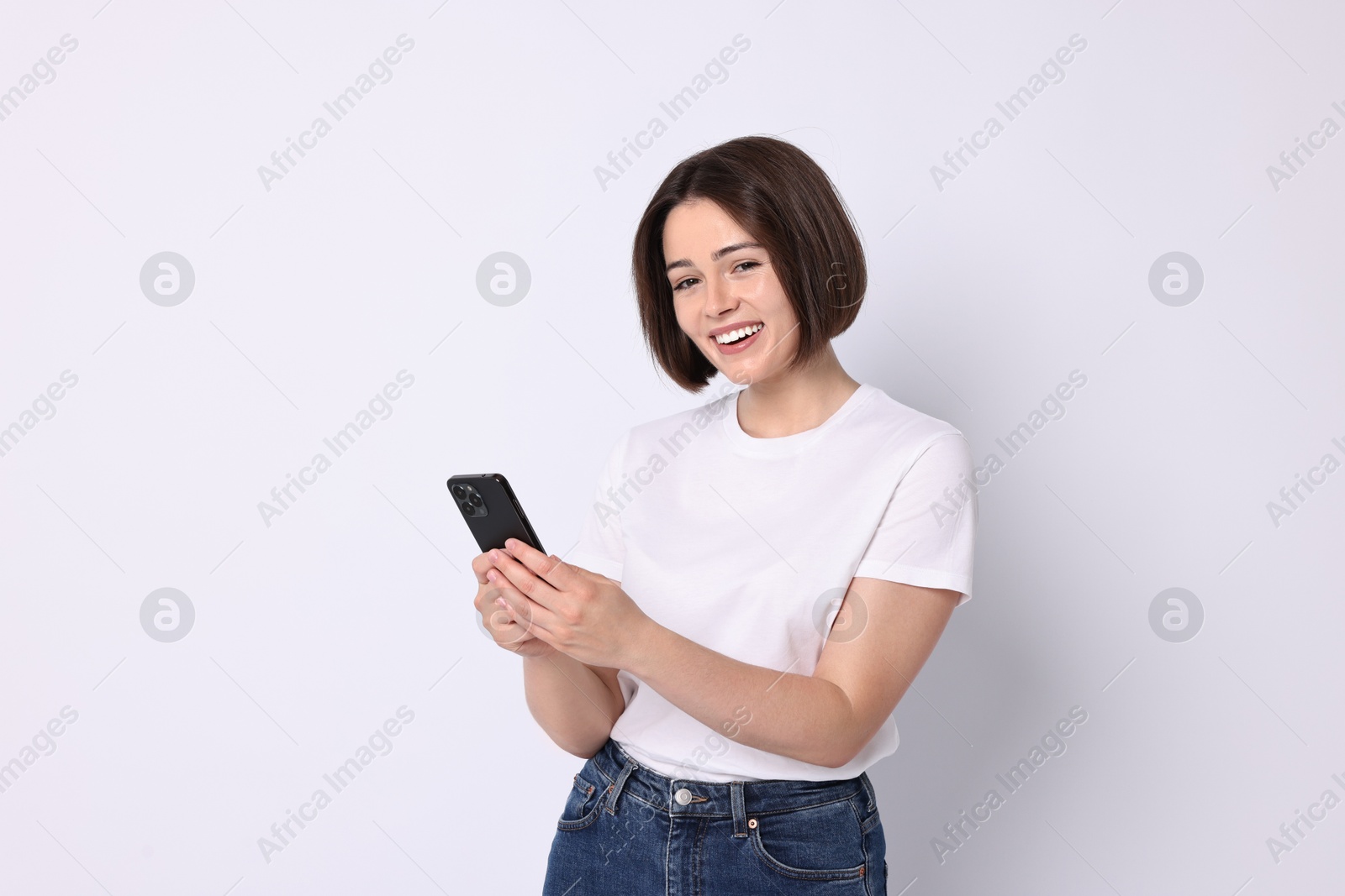 Photo of Happy woman with smartphone on white background