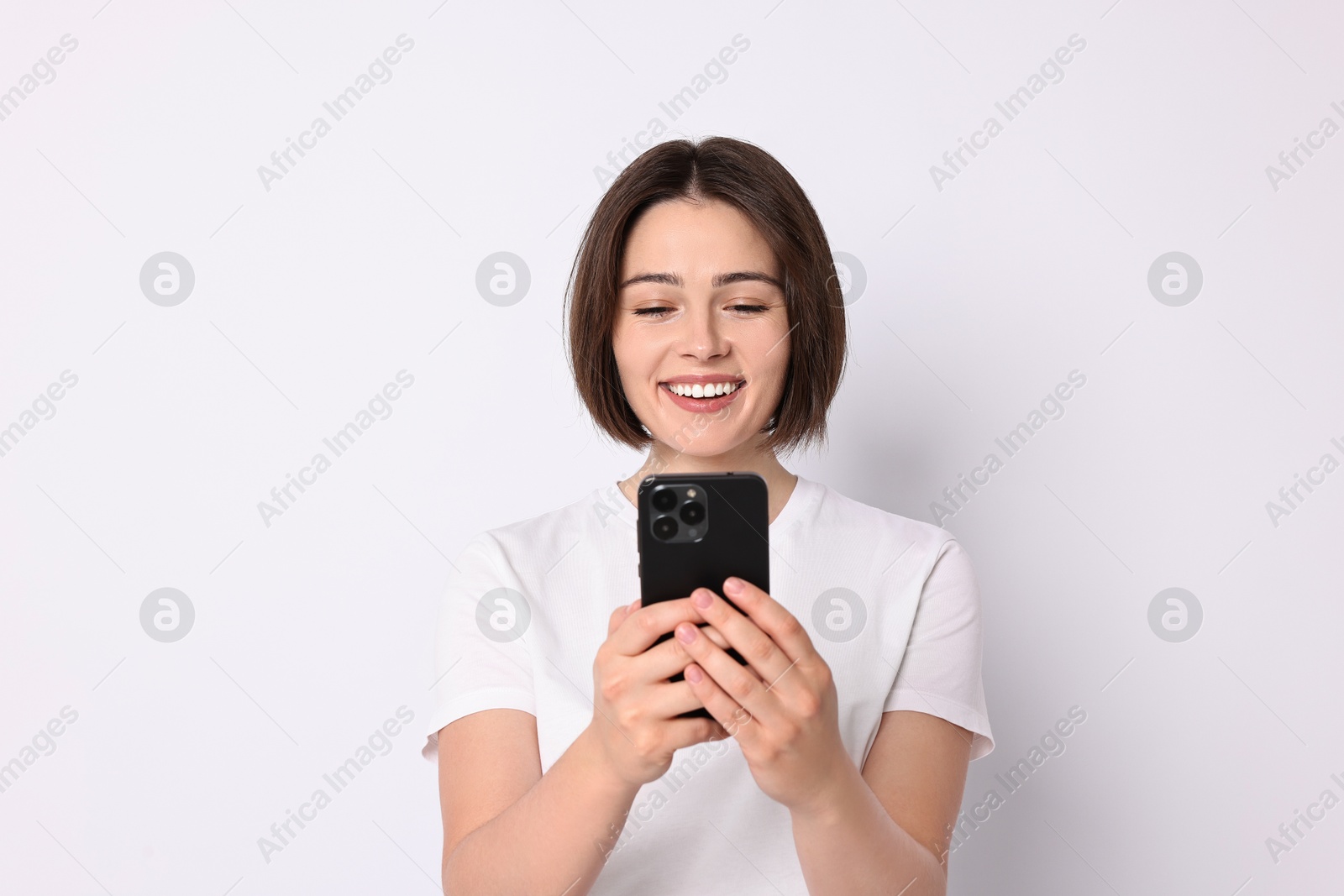 Photo of Happy woman with smartphone on white background