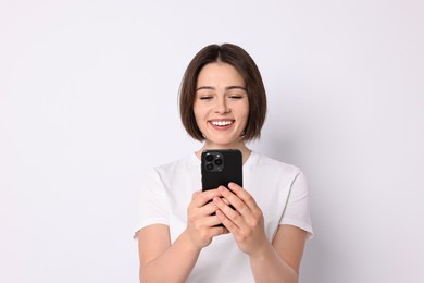 Happy woman with smartphone on white background