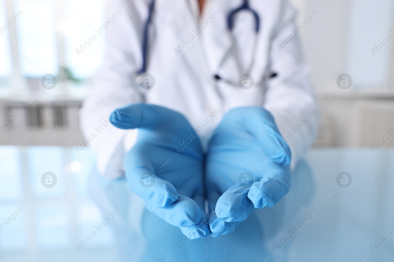 Photo of Doctor holding something at table in clinic, closeup