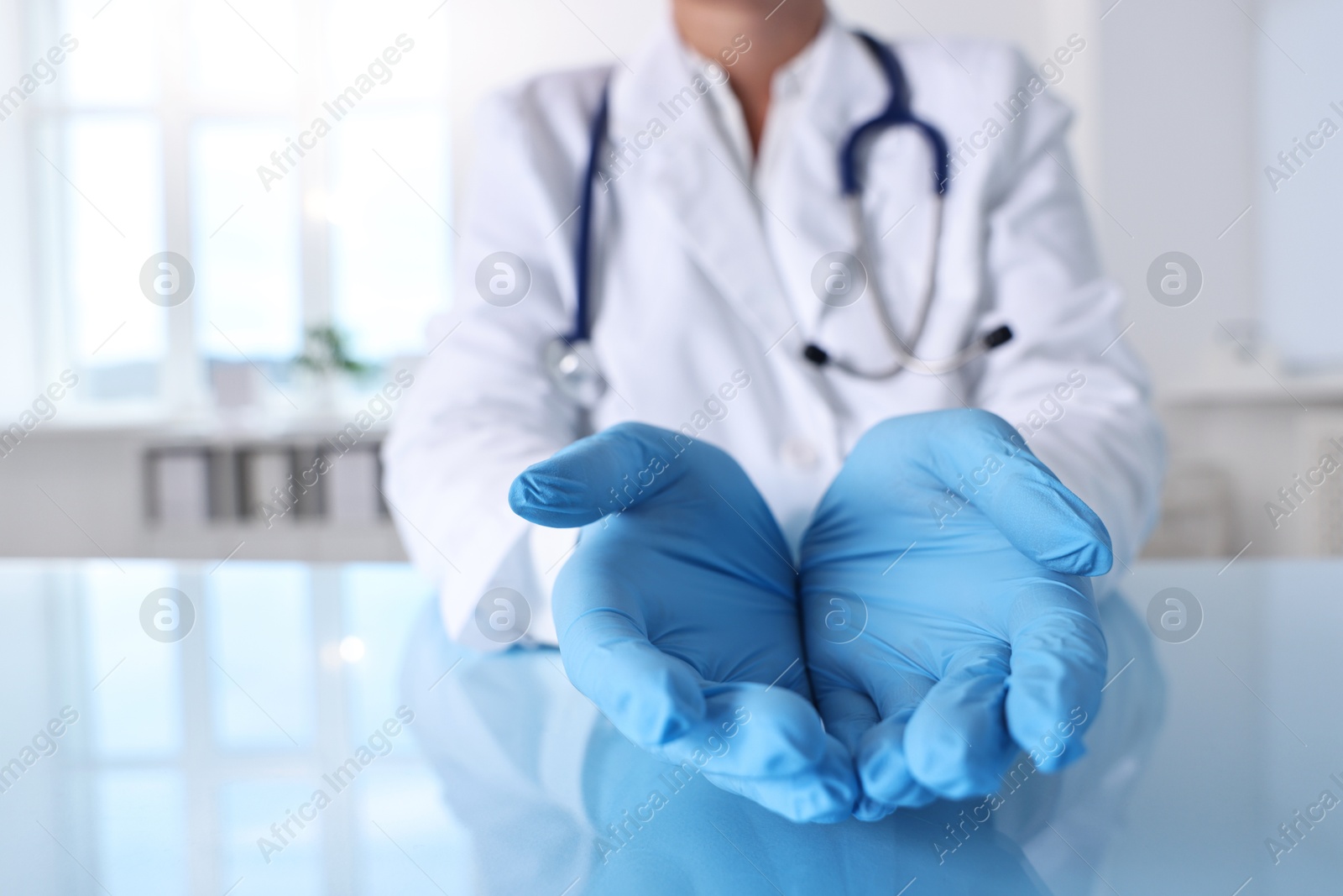 Photo of Doctor holding something at table in clinic, closeup