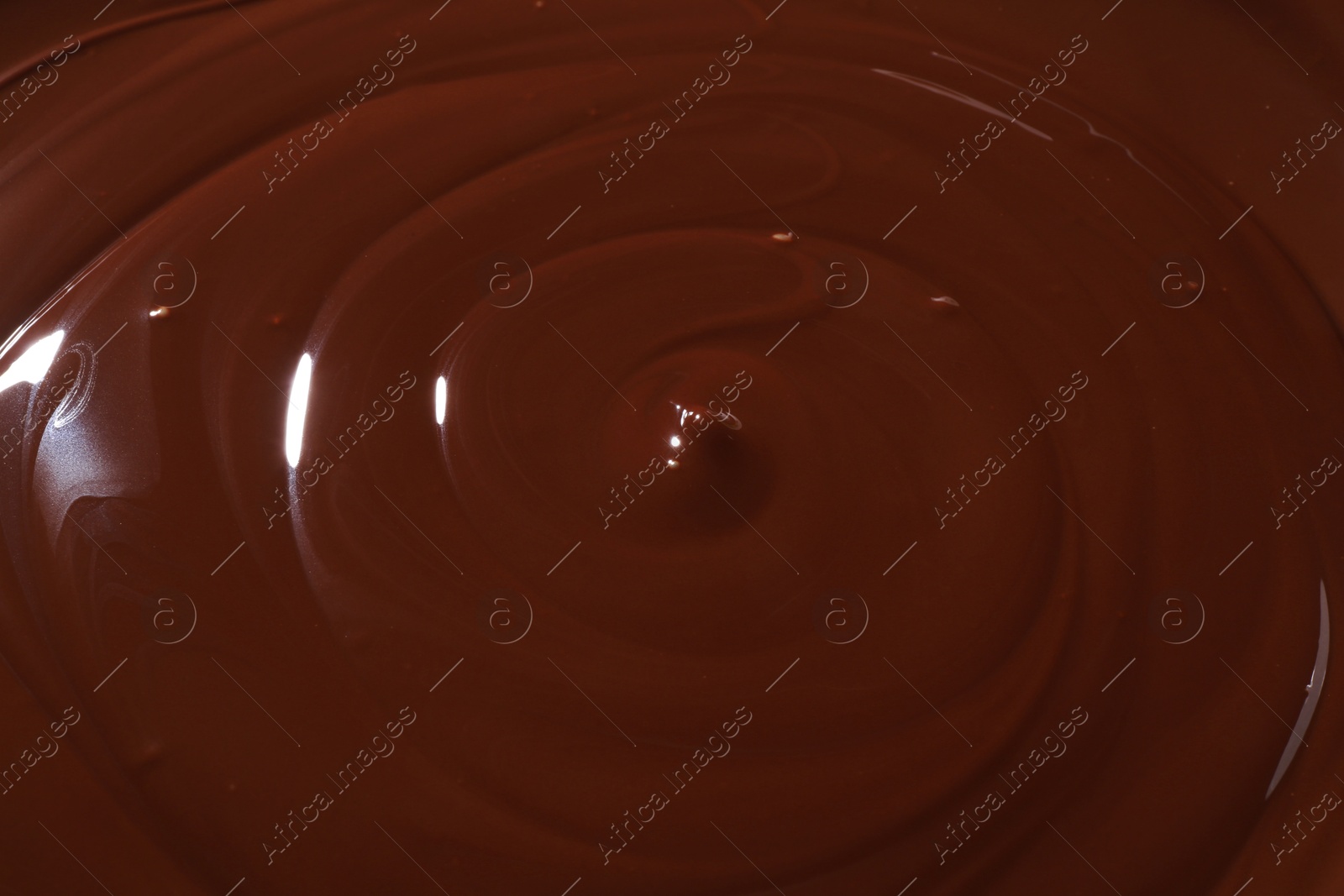 Photo of Tasty melted chocolate as background, closeup view