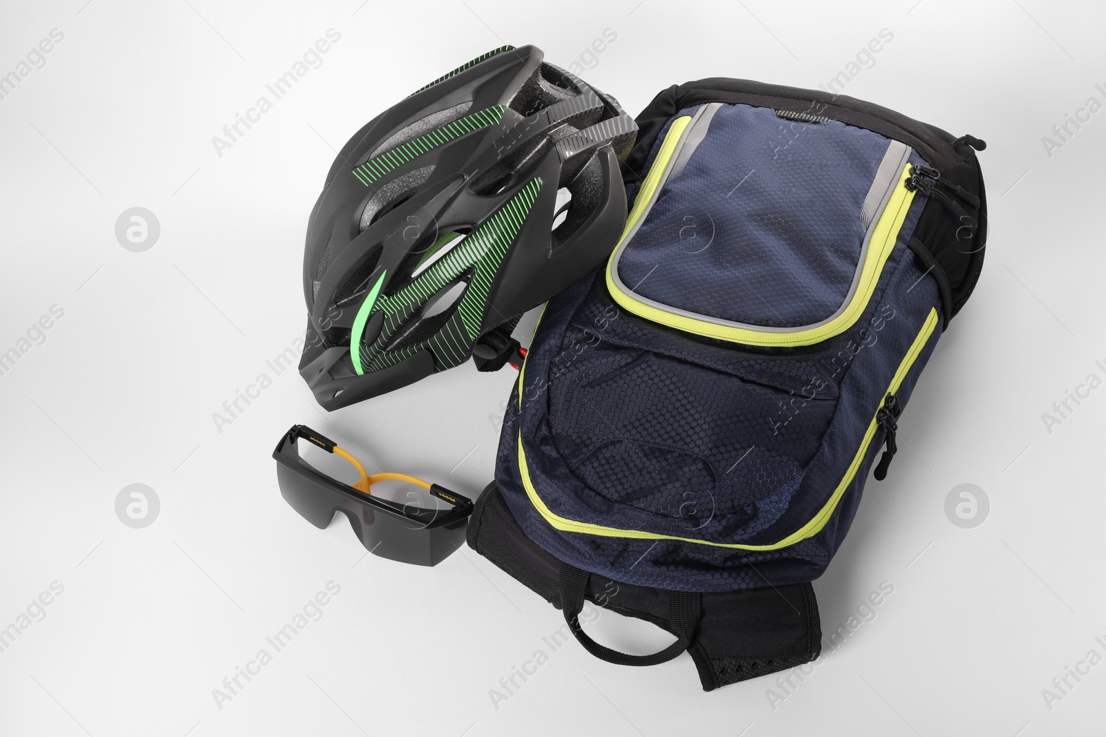 Photo of Backpack, bicycle helmet and goggles isolated on white