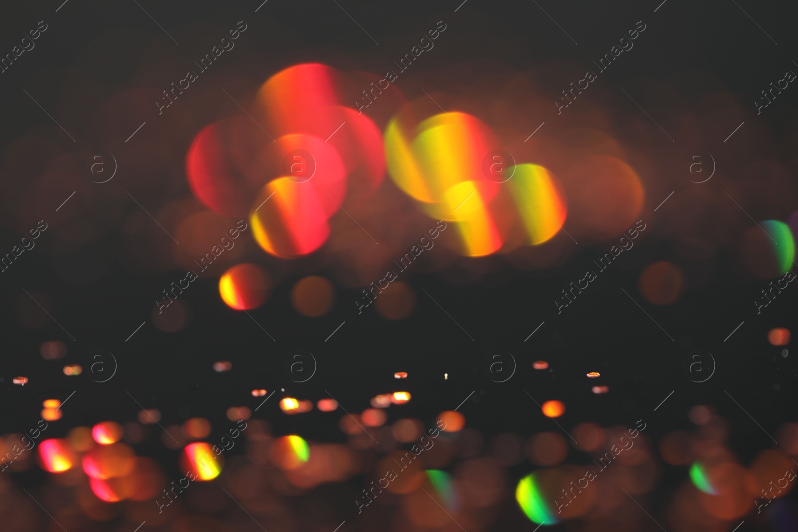 Photo of Beautiful shiny golden glitter on black background, closeup