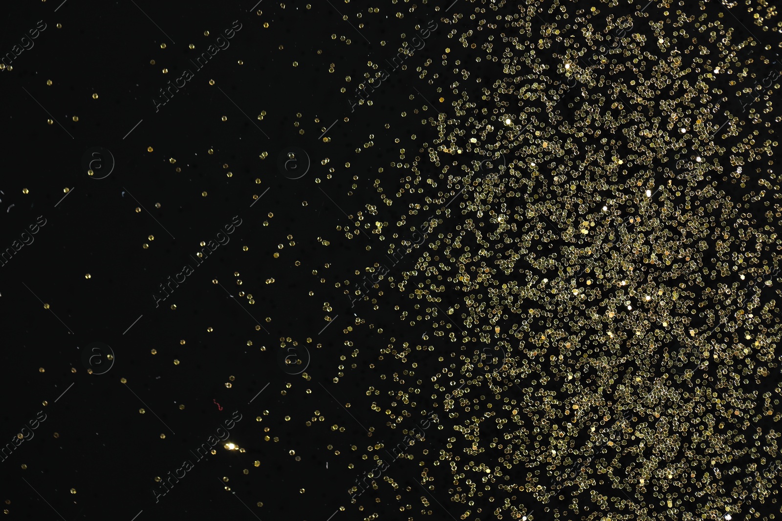 Photo of Beautiful shiny golden glitter on black background, top view