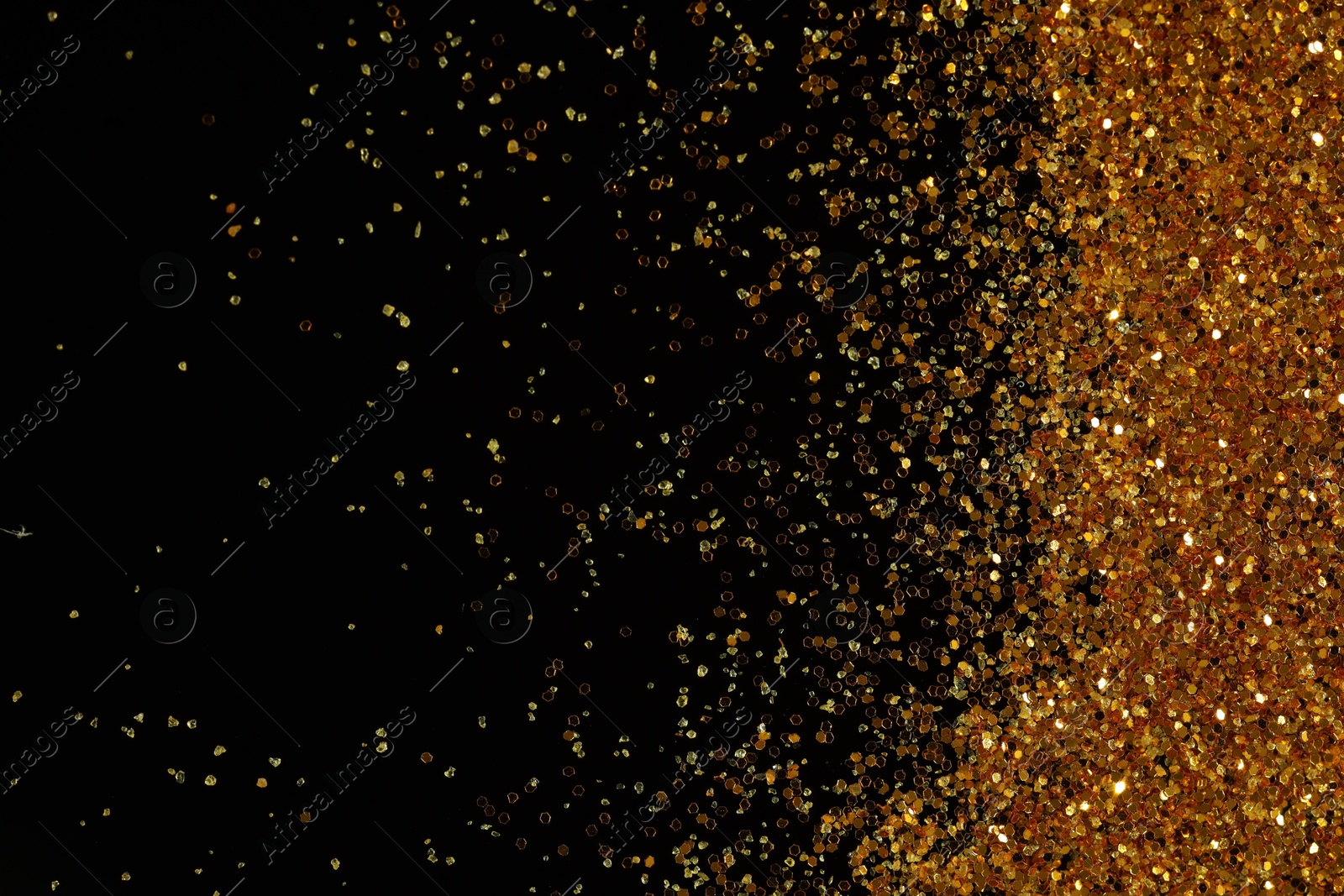 Photo of Beautiful shiny golden glitter on black background, top view