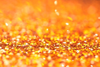 Photo of Beautiful shiny golden glitter as background, closeup