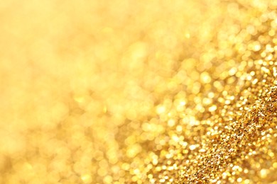 Photo of Beautiful shiny golden glitter as background, closeup