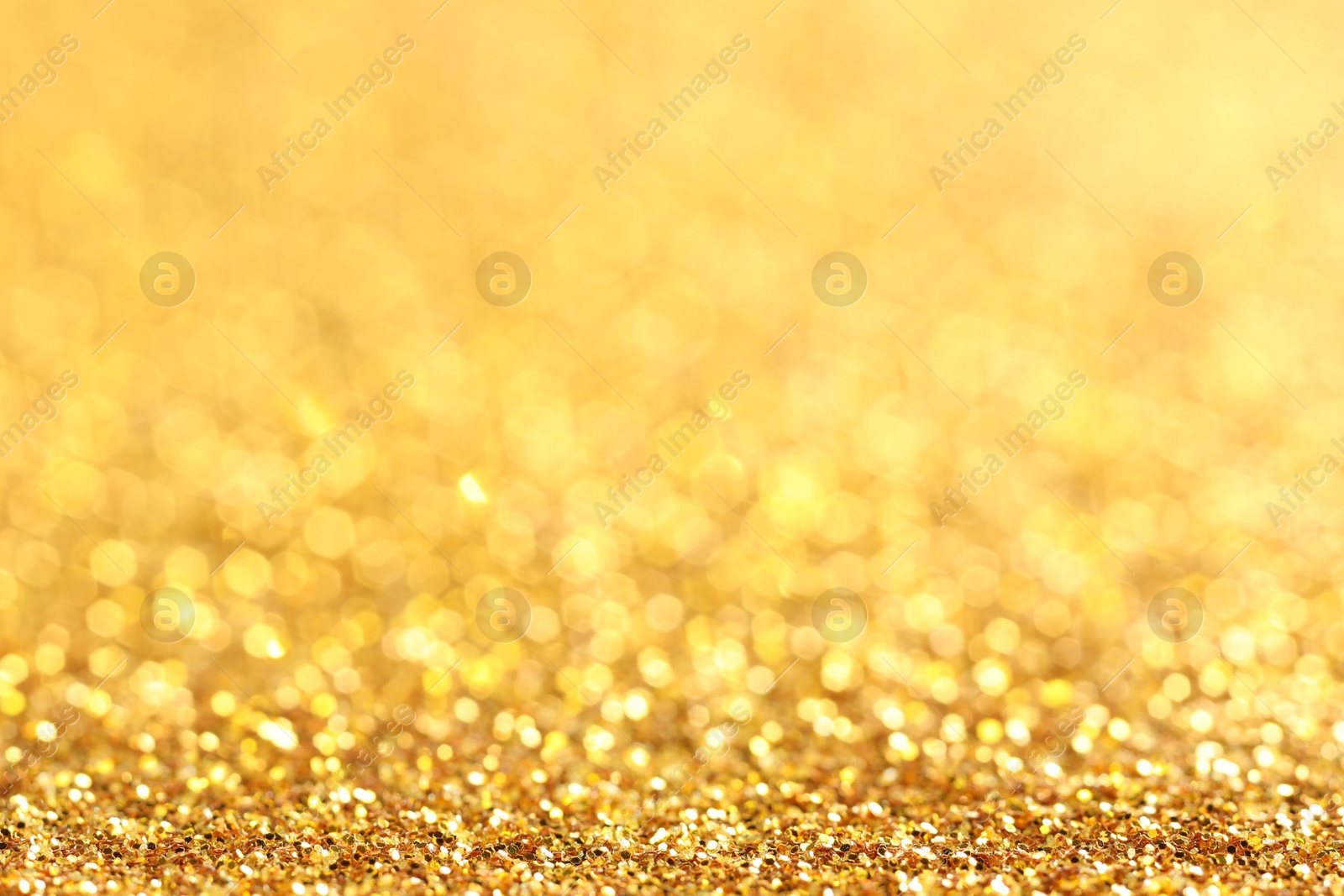 Photo of Beautiful shiny golden glitter as background, closeup