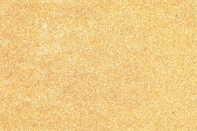 Photo of Beautiful shiny golden glitter as background, top view