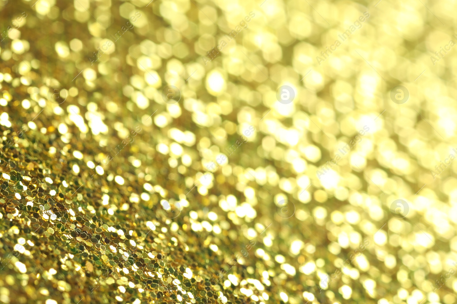 Photo of Beautiful shiny golden glitter as background, closeup