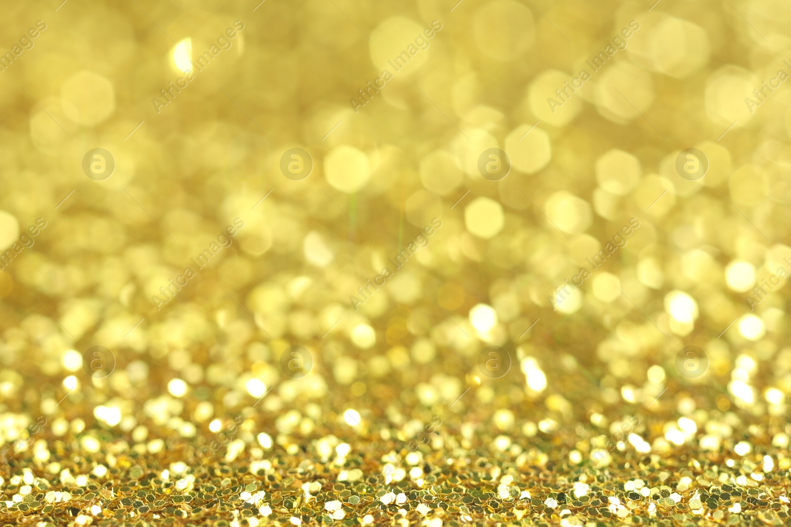 Photo of Beautiful shiny golden glitter as background, closeup