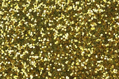 Photo of Beautiful shiny golden glitter as background, top view