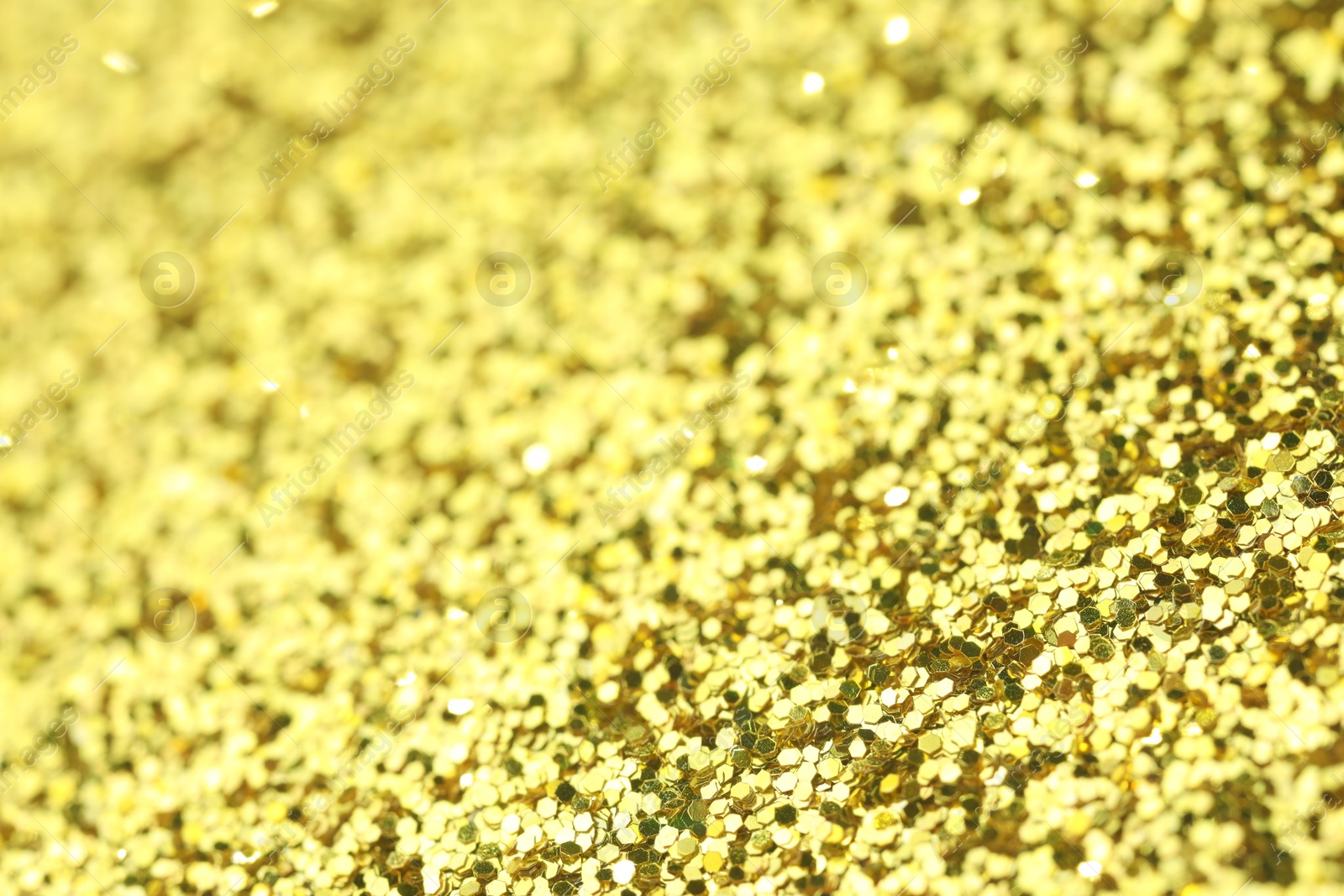 Photo of Beautiful shiny golden glitter as background, closeup