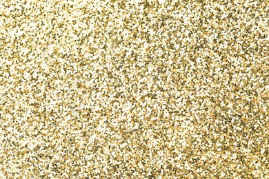 Photo of Beautiful shiny golden glitter as background, top view